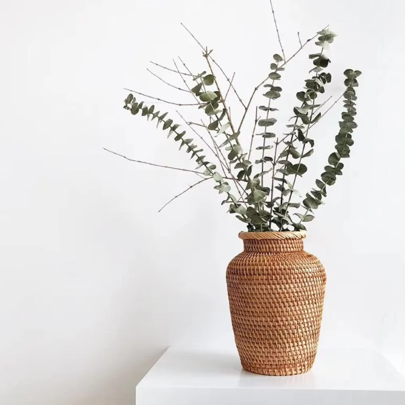 Handwoven rattan vase for adding texture and natural charm to your decor.