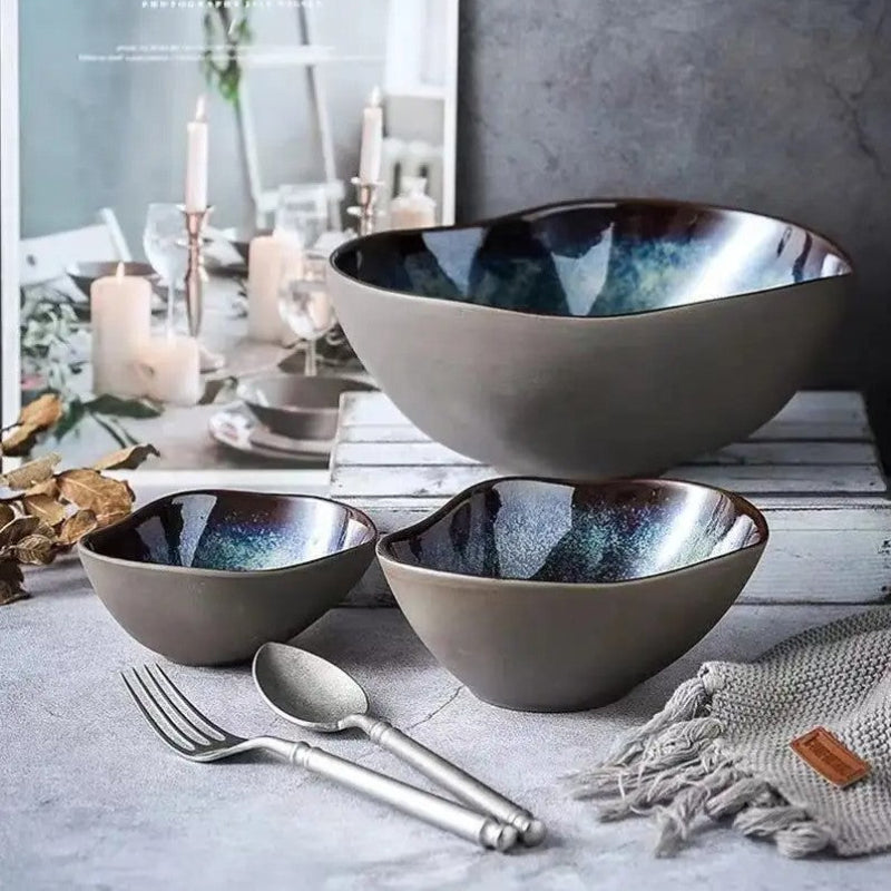Set of ceramic bowls on a table with a magazine in the background