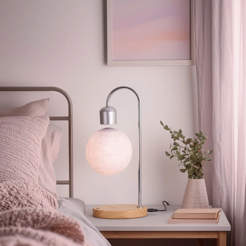 Modern table lamp on a bedside table with a cozy bedroom setting.