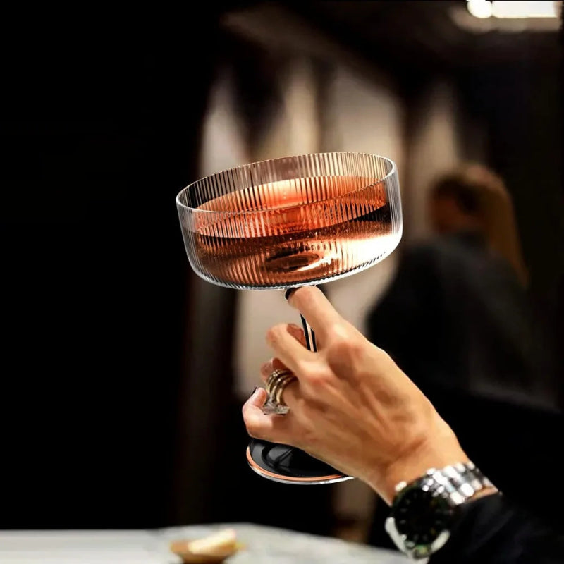 Hand holding a glass of rose wine with a blurred background