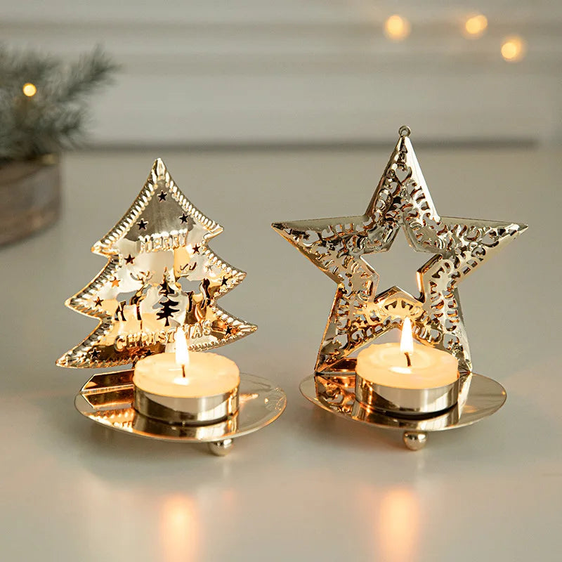 Two gold-colored metal tea light holders, one shaped like a Christmas tree and the other a star, both with lit candles.