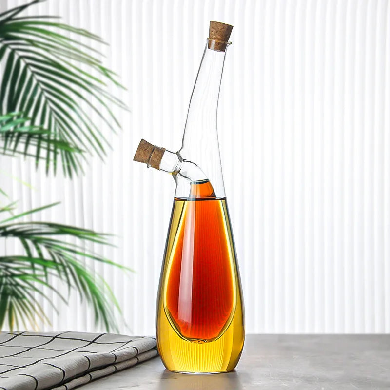 Glass decanter with cork stoppers on a light surface with a plant in the background