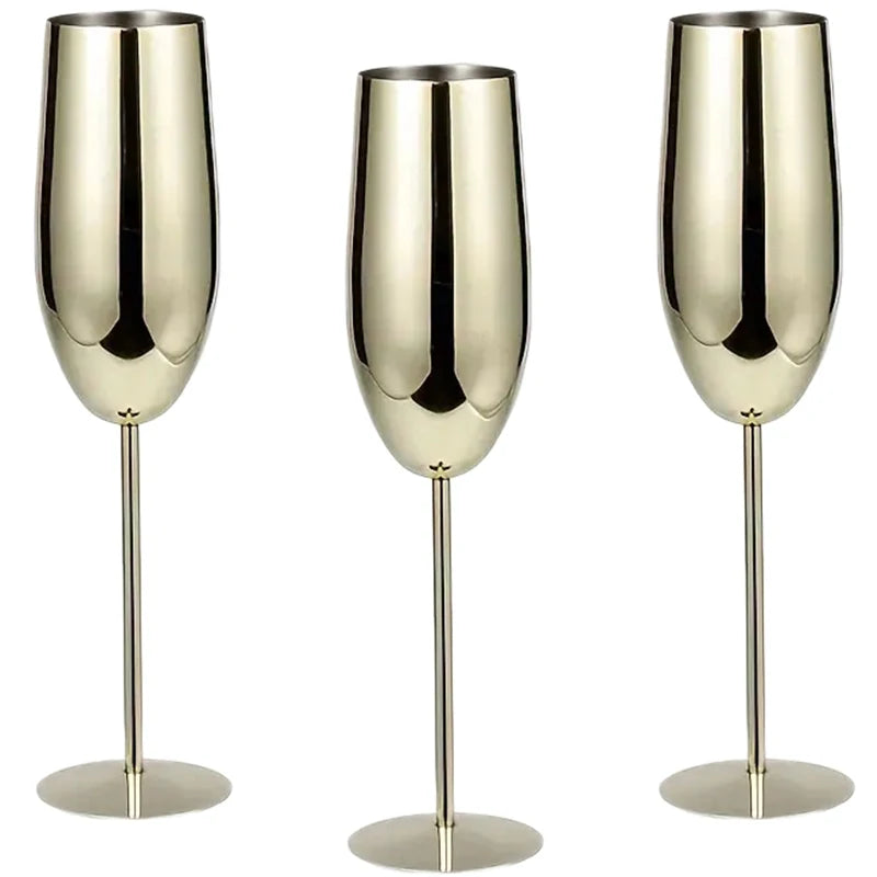 A set of three elegant gold stainless steel champagne flutes with a sleek, modern design, featuring a reflective finish and long, slender stems—perfect for special occasions and celebrations.