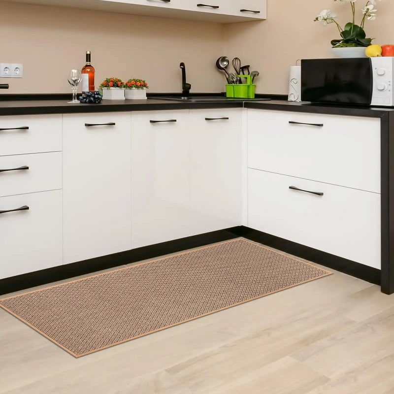 Kitchen with white cabinets, black countertops, and a woven mat on the floor.