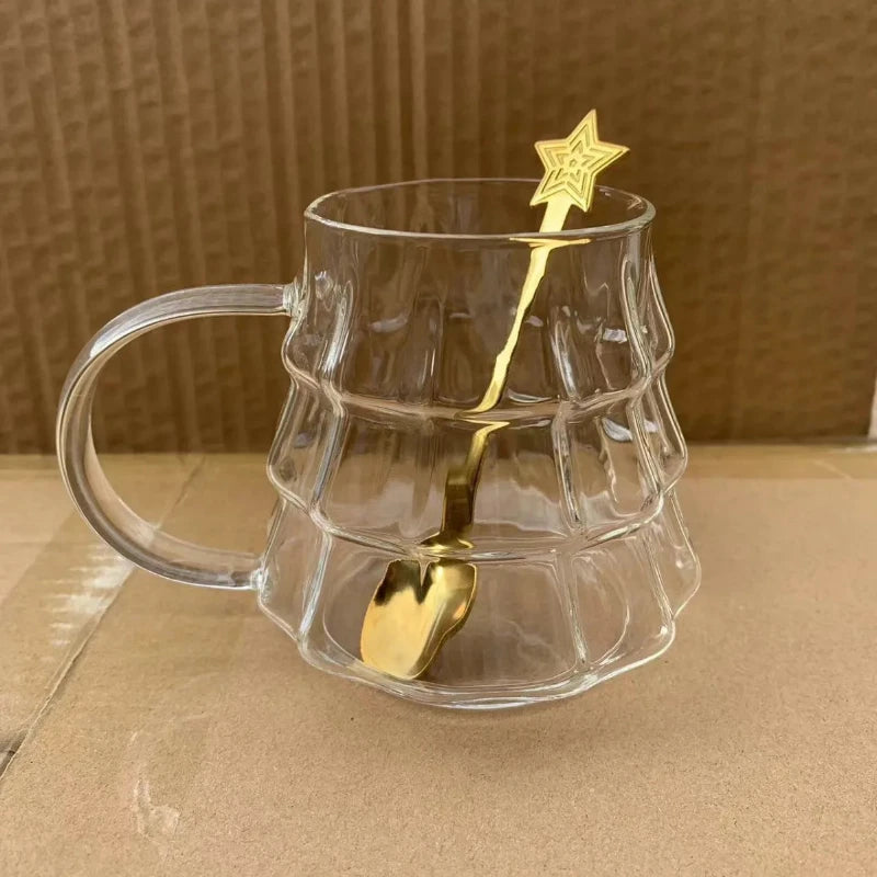 Two tree-shaped glasses, one with a white beverage and the other with a brown beverage, likely meant for serving hot cocoa and eggnog during the holiday season.