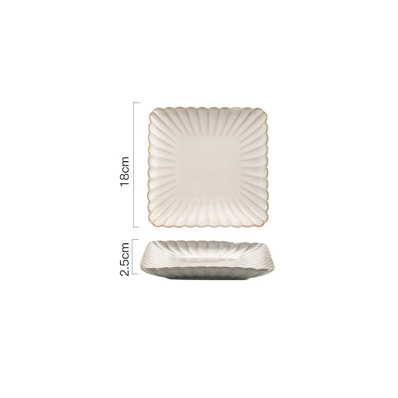 A square ceramic plate with a scalloped rim and a ribbed design, measuring 18cm by 18cm and 2.5cm in height.
