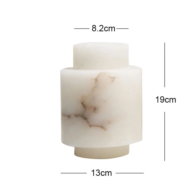 A cylindrical alabaster vase with a modern, layered design. The vase is predominantly white with natural brown veining, giving it a marble-like appearance. Dimensions are labeled: 8.2 cm for the top opening, 13 cm for the widest section, and 19 cm in height.