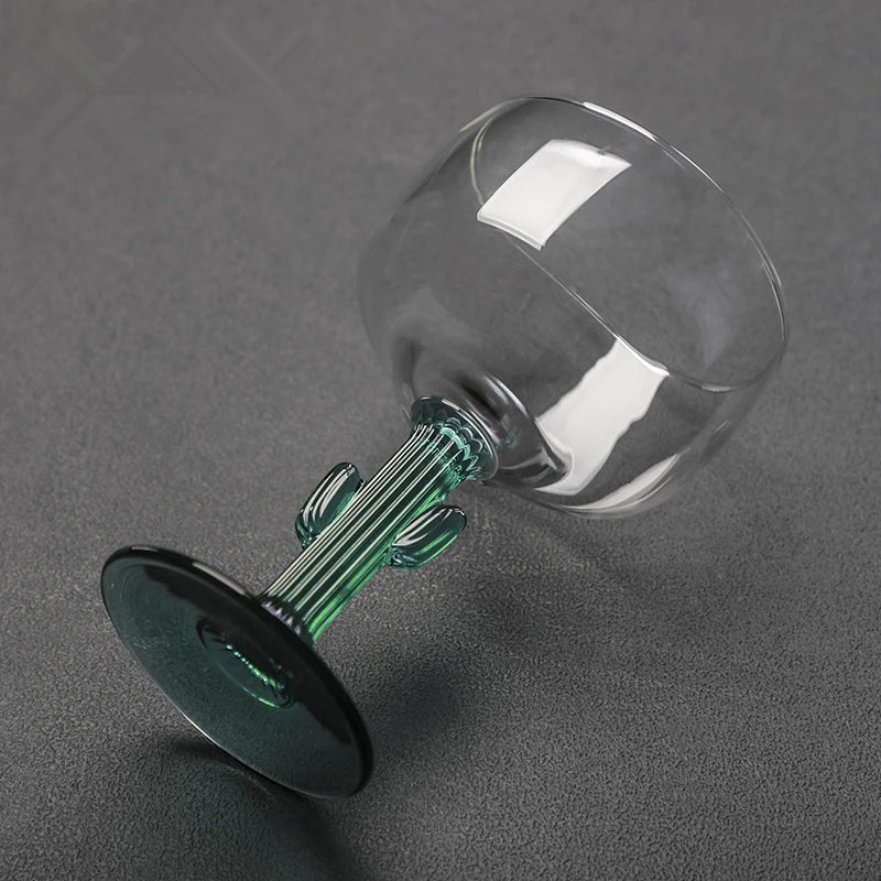 Glass decanter with green stopper on a gray background