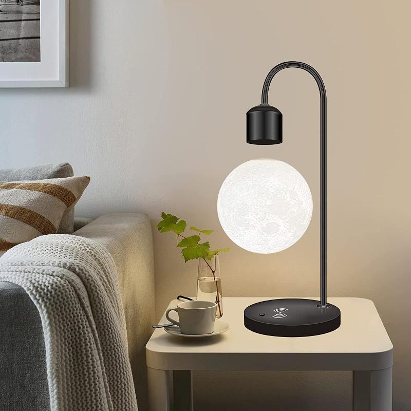 Stylish levitating moon lamp with wireless charging capabilities, perfect for adding a unique and functional piece to your space.