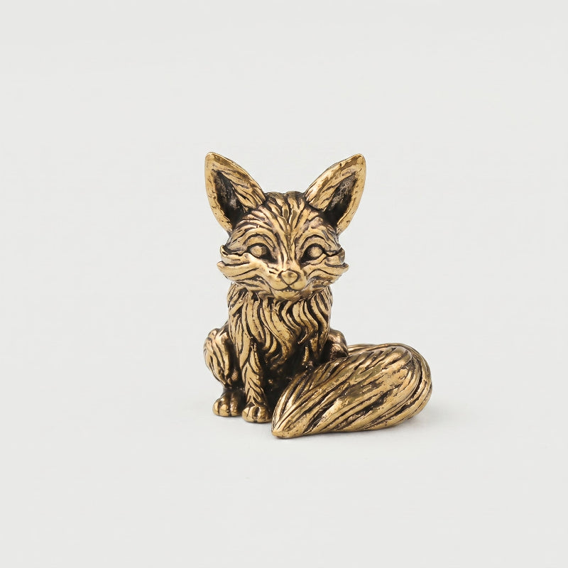 Brass fox figurine front-angle hero shot on a neutral studio background