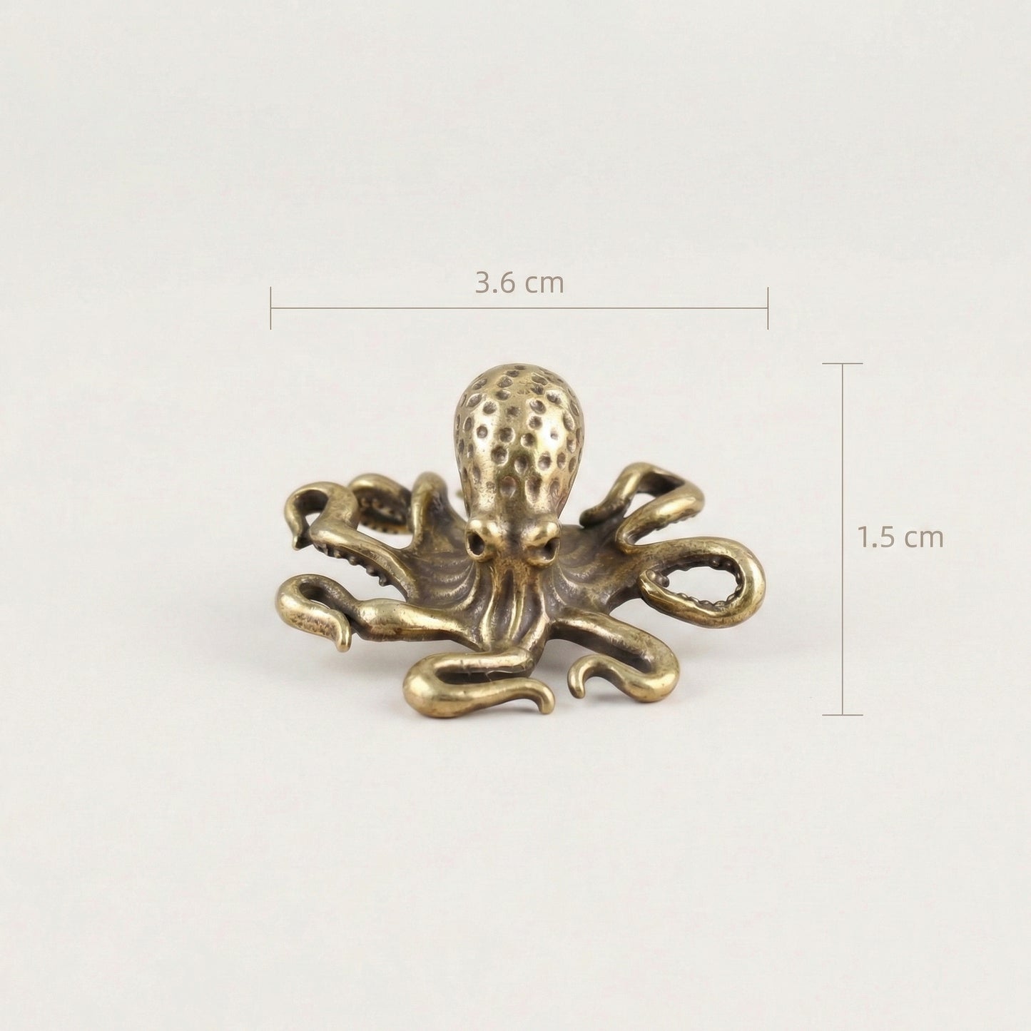 Brass octopus sculpture with labeled dimensions showing size measurements.