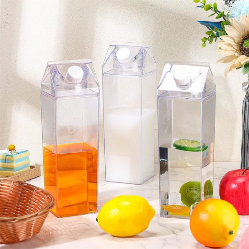 Clear plastic carton boxes with colorful contents on a table with fruits and a cake.