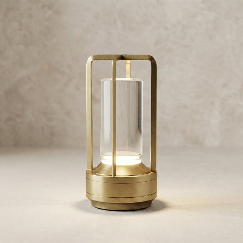 Gold table lamp with glass shade on a neutral background
