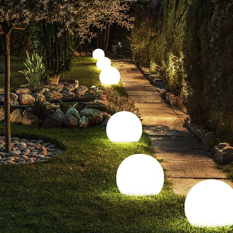 Glowing, round lights are strung across an outdoor space.