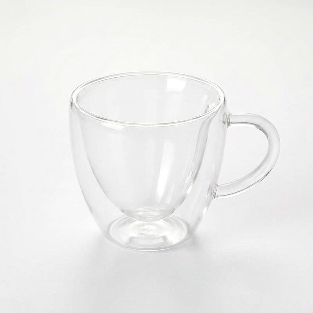 Large empty heart-shaped glass mug on a plain white background