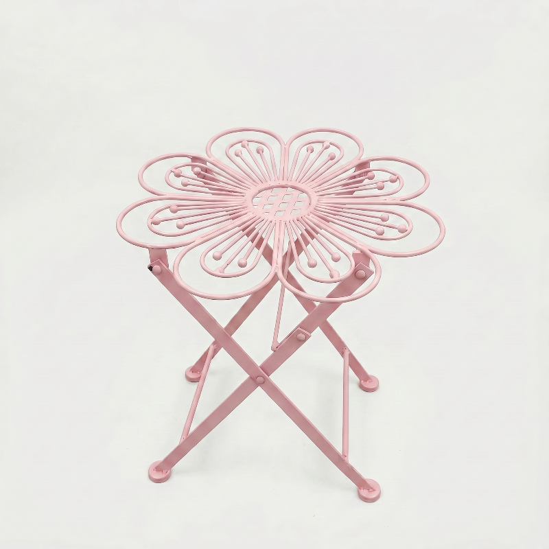 Metal flower bistro table in pink on white background