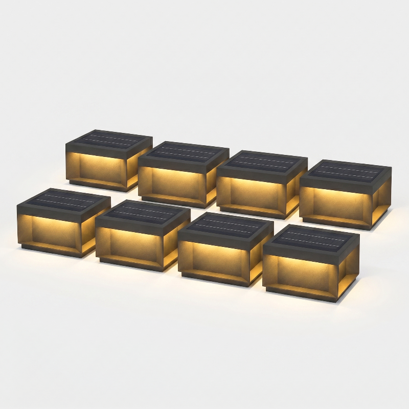 Set of eight modern black LED solar outdoor deck lights on white background