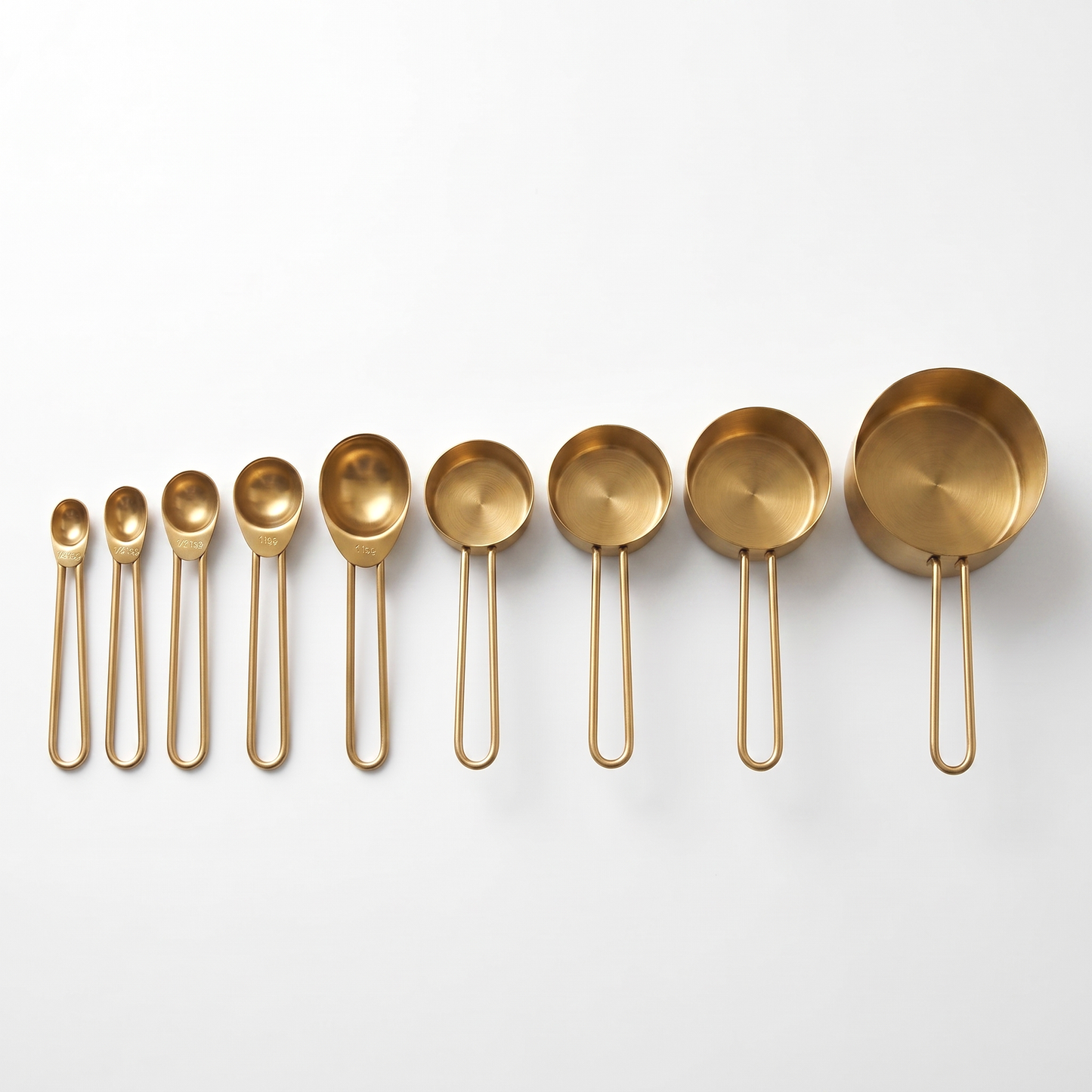 9-Piece Gold Stainless Steel Measuring Set with 5 spoons and 4 cups arranged on a clean off-white background