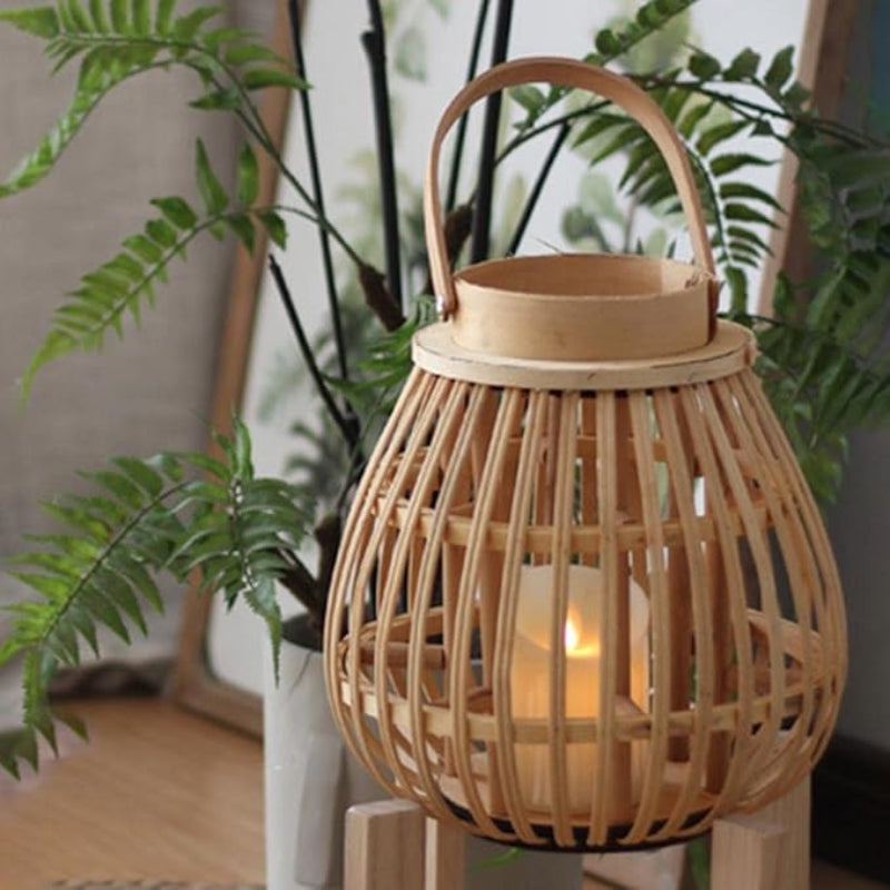 Woven bamboo lantern with a curved frame, leather handle, and a glass candle holder, creating a warm and natural ambiance.