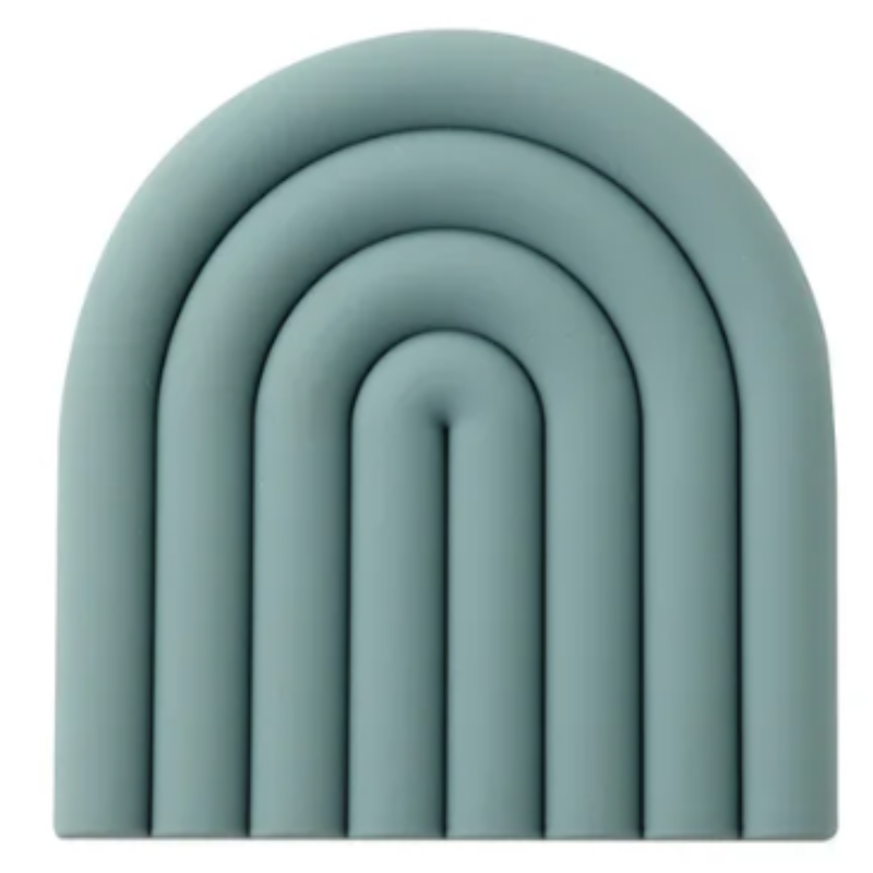 A muted teal blue silicone trivet or coaster with a modern, segmented rainbow arch design is shown against a white background. The trivet has five raised, semi-circular segments.