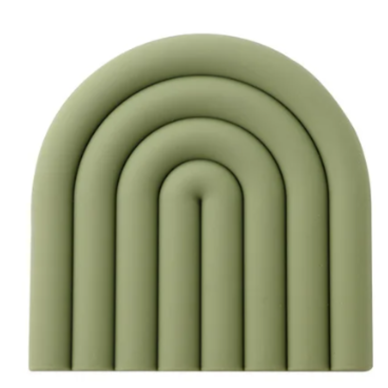 A muted green silicone trivet or coaster with a modern, segmented rainbow arch design is shown against a white background. The trivet has five raised, semi-circular segments.