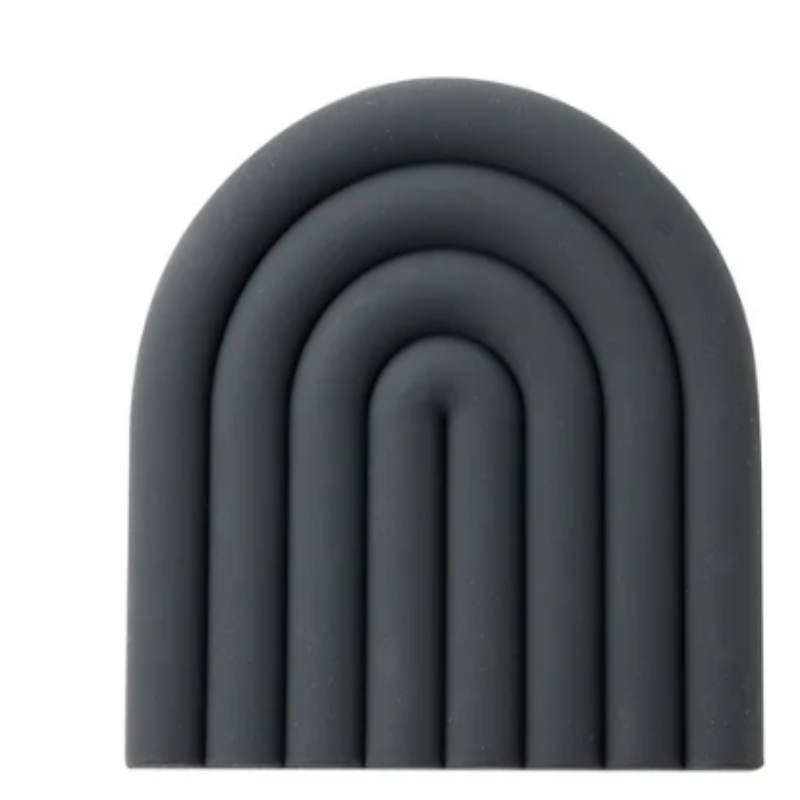 A dark gray silicone trivet or coaster with a modern, segmented rainbow arch design is shown against a white background. The trivet has five raised, semi-circular segments.
