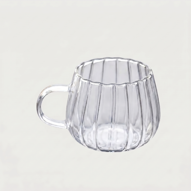 Ribbed glass mug on white background side view
