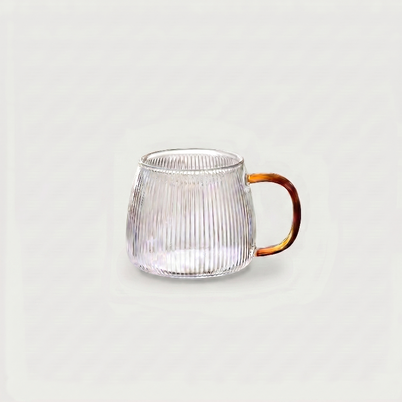 Small ribbed glass mug on white background