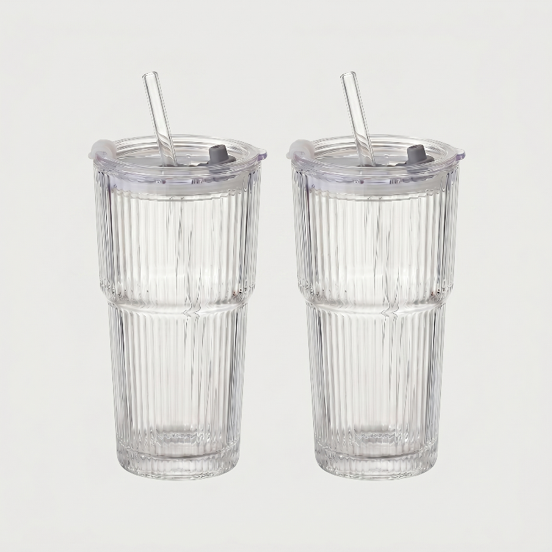 Set of two ribbed glass tumblers on white background