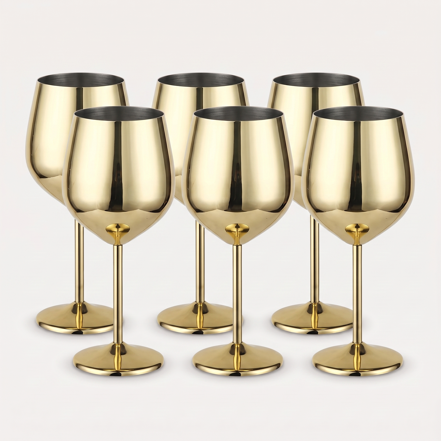 Set of six gold stainless steel stemmed wine glasses with a mirror-polished finish on a clean off-white background