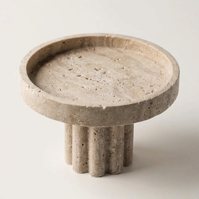 Concrete trivet with three cylindrical legs on a light background