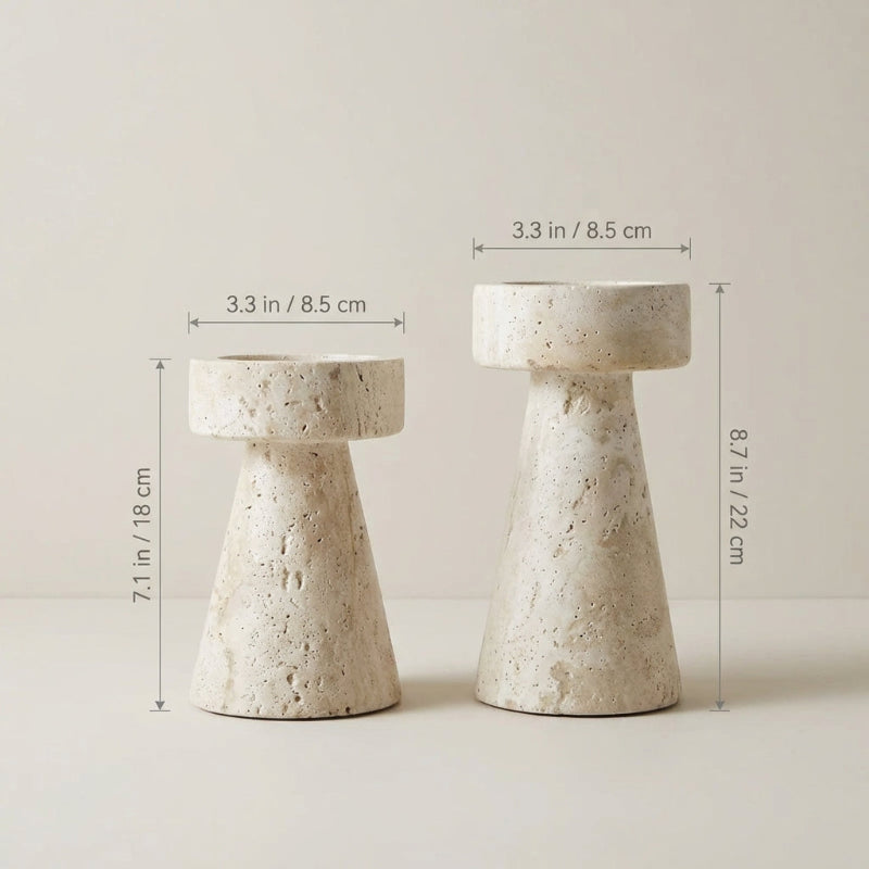 Two stone-colored candle holders with measurements on a light background