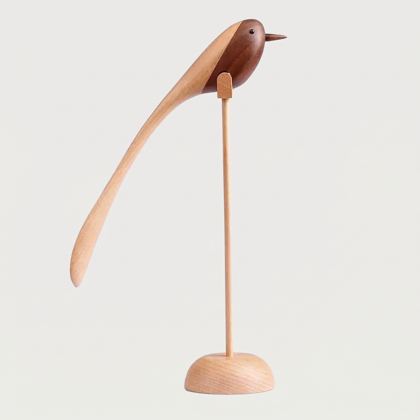 Two-Tone Wood Bird Sculpture hero shot with a lighter wood grain on a thin dowel and round base against a clean off-white background
