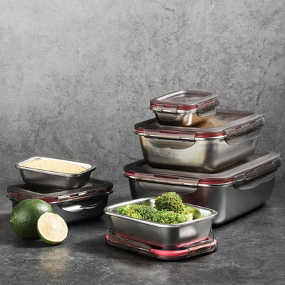 An assortment of stainless steel food containers, some filled with food, arranged on a dark surface.