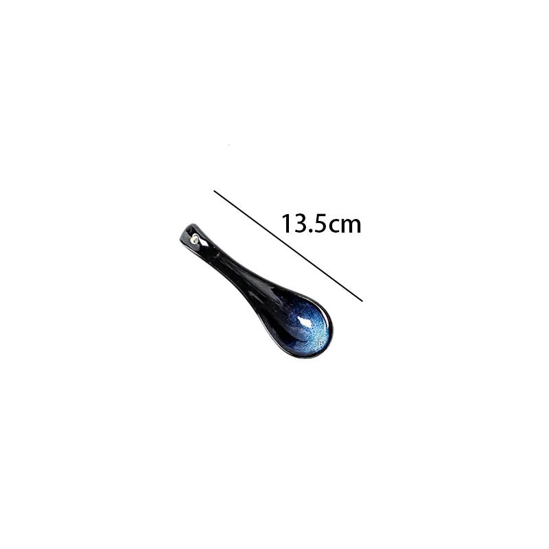 A ceramic serving spoon with a dark blue textured bowl, showing its length as 13.5cm.