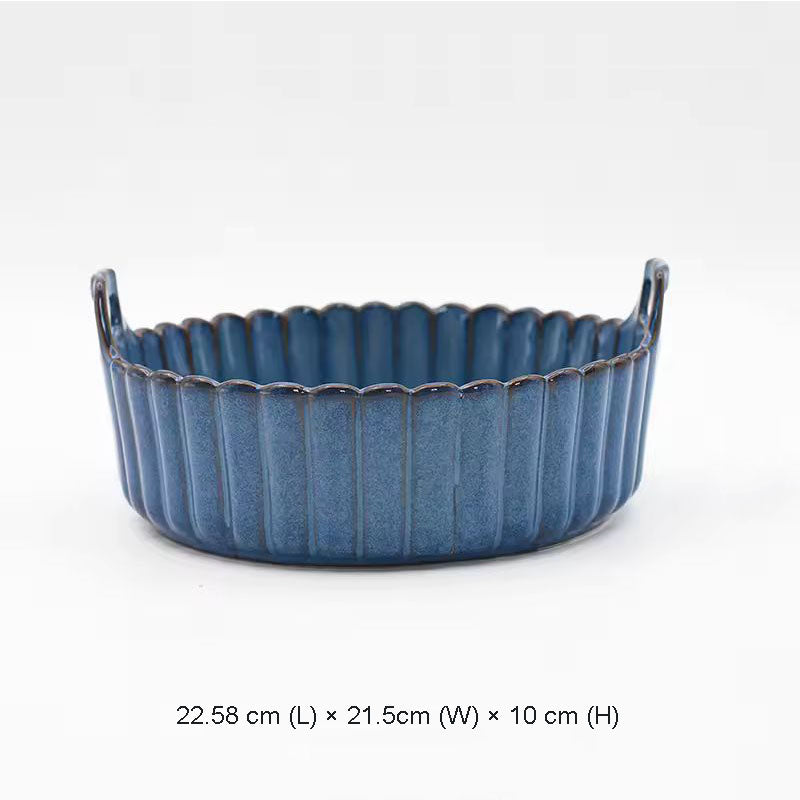 A larger blue ceramic baking dish with scalloped edges and two small handles.