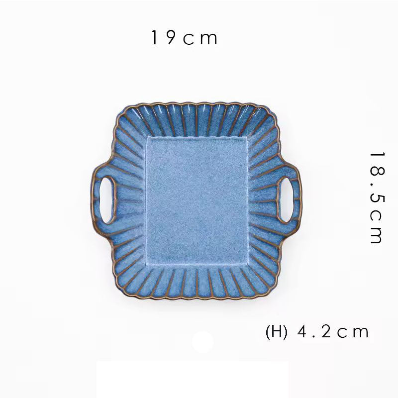 A square blue ceramic serving dish with handles.