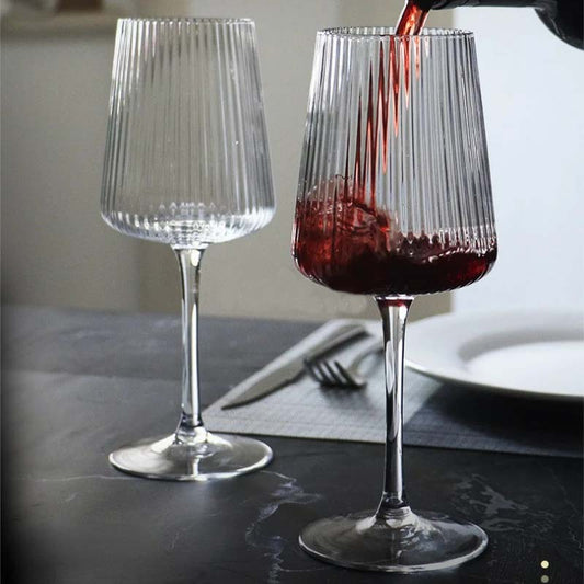 Red wine being poured into a glass.
