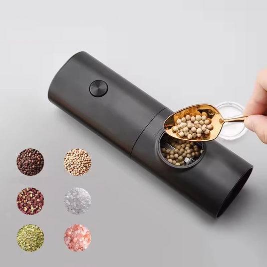 A person using a small gold scoop to fill a black automatic spice grinder with white peppercorns, with an illustration of various spices next to it.