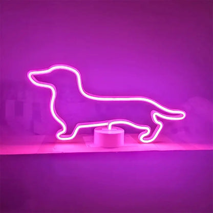 A bright neon sign shaped like a dachshund dog, glowing pink, sitting on a white circular base.