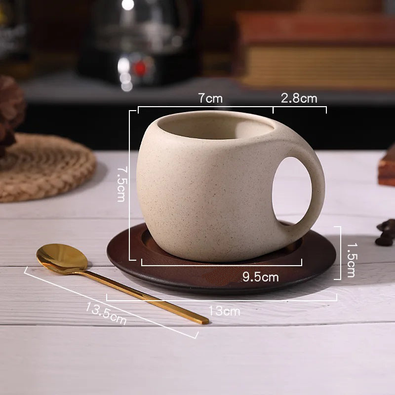 Coffee cup with measurements, saucer, and spoon on a white table.
