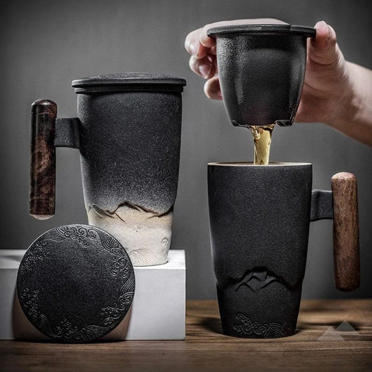 Thermal mug with wood handle, lid and infuser shown with tea being poured