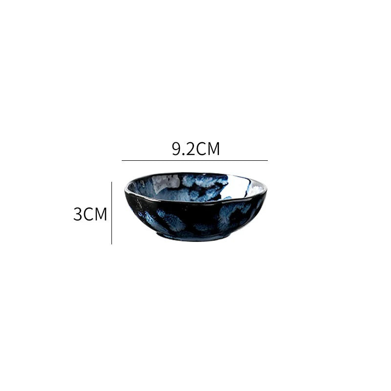 A small, round ceramic dipping bowl with a dark blue and white textured pattern, showing its dimensions: 9.2cm in diameter and 3cm in height.