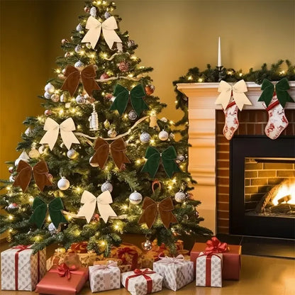 Christmas tree decorated with ornaments, lights, and velvet bows in cream, brown, and green, next to a fireplace.