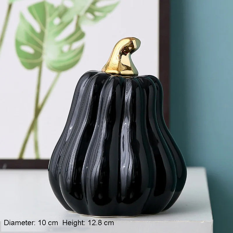 A black ceramic pumpkin with a gold stem.