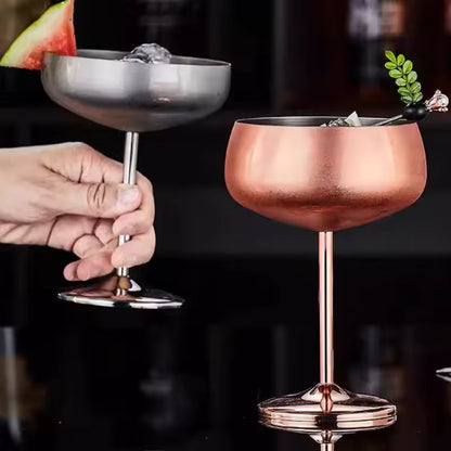 Two metallic cocktail glasses, one silver and one rose gold, on a dark background.