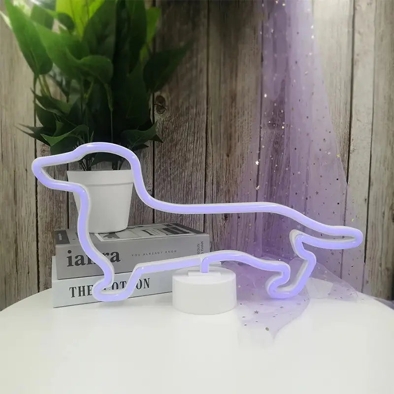 A subtle neon sign shaped like a dachshund dog, glowing a pale lavender or white, resting on a stack of books.
