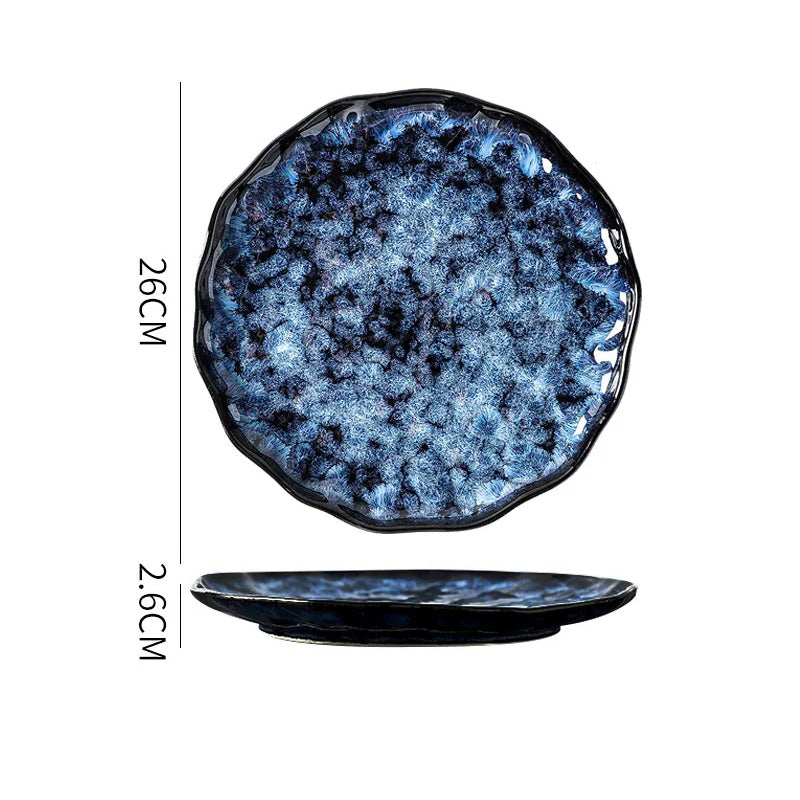 A round, shallow, dark blue and white textured ceramic plate with a wavy edge, showing its dimensions: 26cm in diameter and 2.6cm in height.