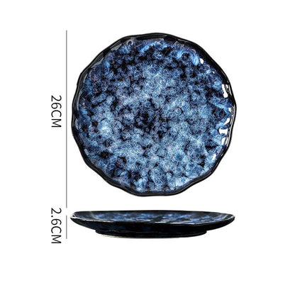 A round, shallow, dark blue and white textured ceramic plate with a wavy edge, showing its dimensions: 26cm in diameter and 2.6cm in height.