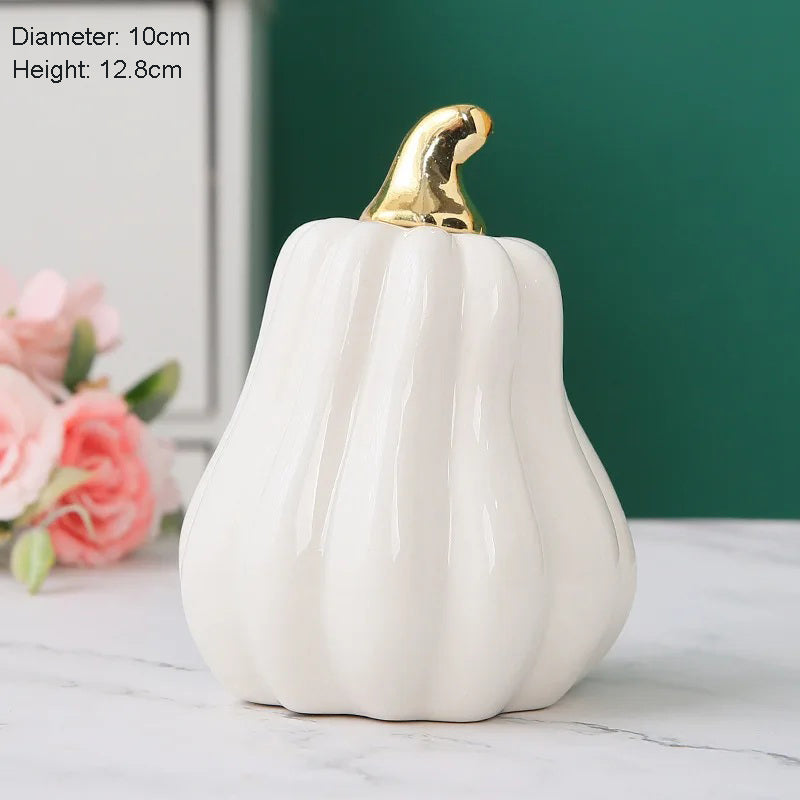 A white ceramic pumpkin with a gold stem.